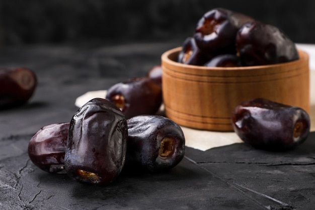 Dates fruit a heap closeup on a dark background