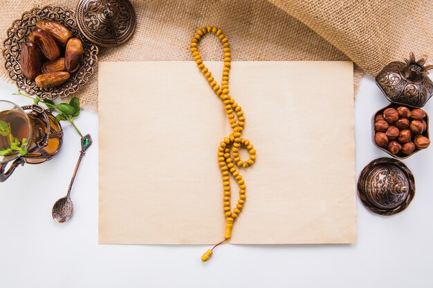 Dates fruit with beads and blank paper 