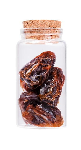 Dates in a glass bottle with cork stopper isolated on white