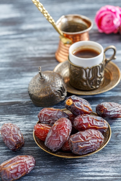 Dates on the plate copper cezve and black coffee