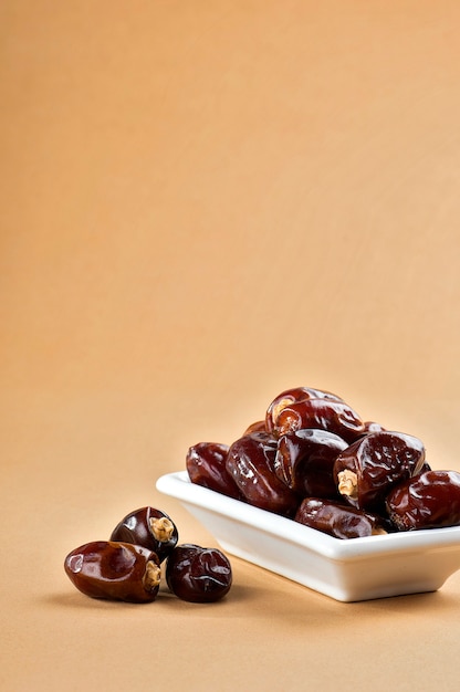 Dates in plate. Dried dates fruits.
