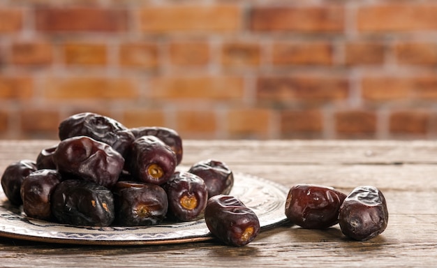 Dates in plate on wooden table