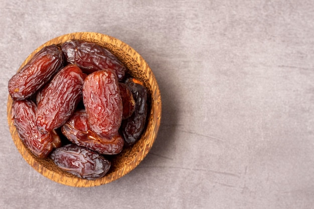 dates in a wooden bowl high angle view