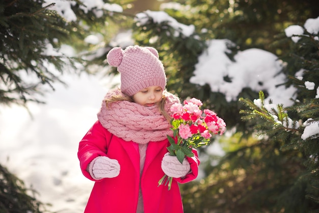 The daughter carries a bouquet to congratulate her mother On Mar