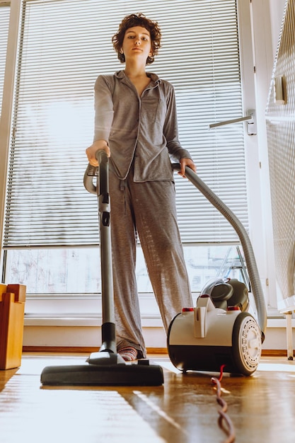 Daughter cleans apartment, does household chores