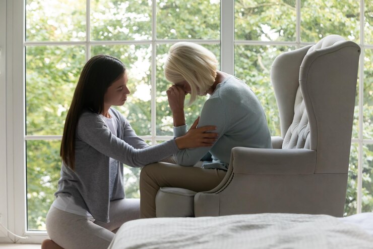 Photo daughter comforting elderly mother sharing difficult life period giving support