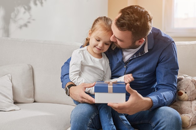 Daughter congratulating father with gift