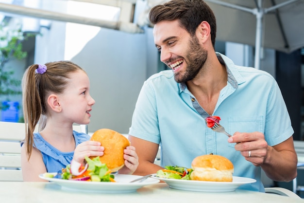 Daughter and father eating at the restaurant