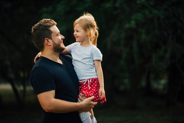 Daughter and father smiling at each other