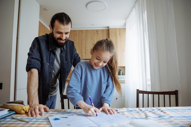 Photo daughter and father do their homework together at home