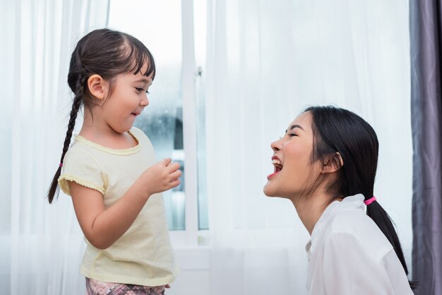 Daughter feeding mom with potato chip funny. Back to school and Education concept