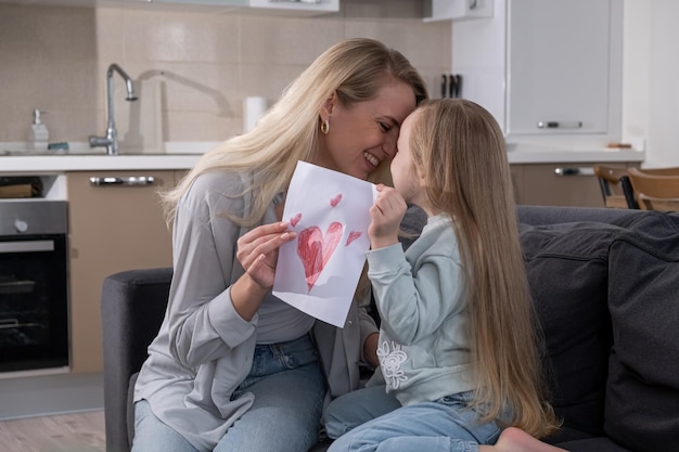 Daughter gives her mother birthday handmade postcard happy birhday celebration with family