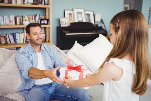 Photo daughter giving gift to father