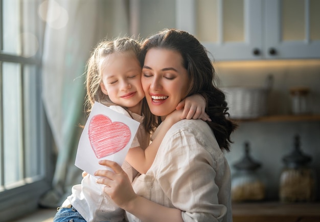 Daughter giving mother bouquet of flowers on mothers day Happy mothers day