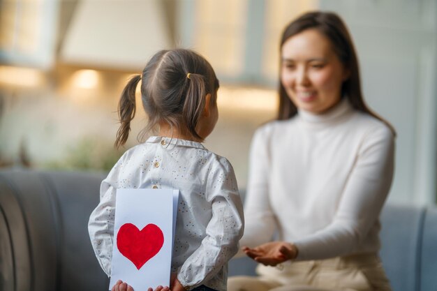 Daughter giving mother postcard