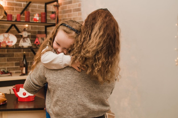 Daughter hugging mom at home