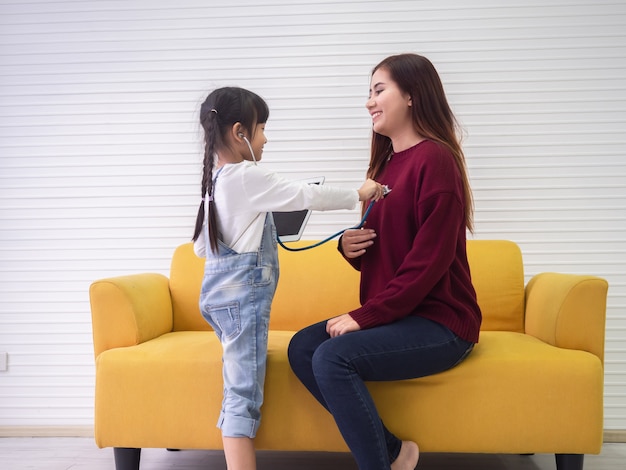 Daughter is checking her mother's health, family concept