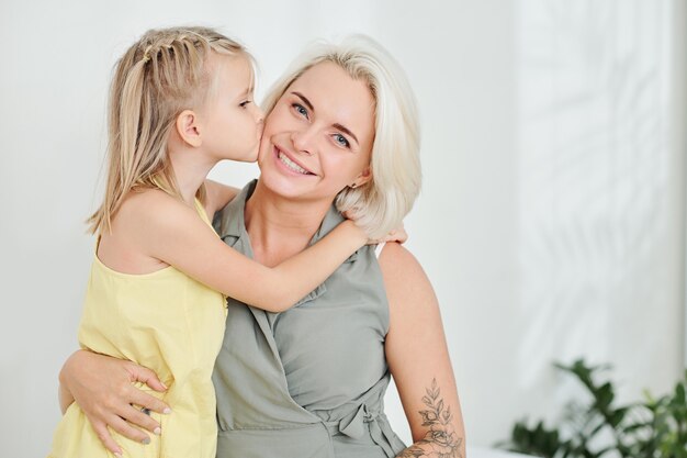 Daughter kissing mother