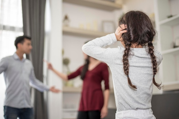 Daughter looking at parents fighting in house