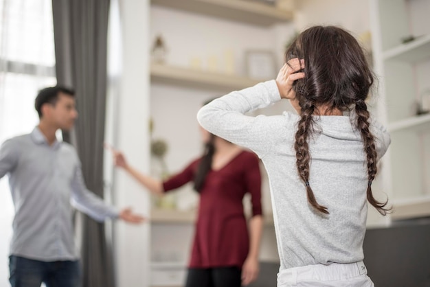 Photo daughter looking at parents fighting in house