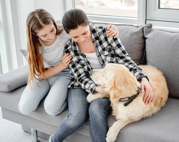 Daughter and mother next to dog