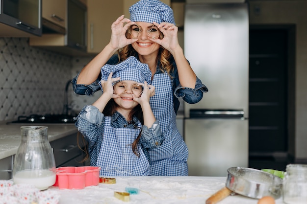 Daughter and mother have a funny time in the kitchen. - Image