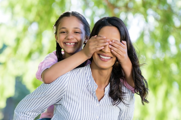 Daughter and mother having fun in park