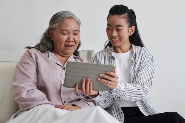 Daughter Showing Show to Sick Mother