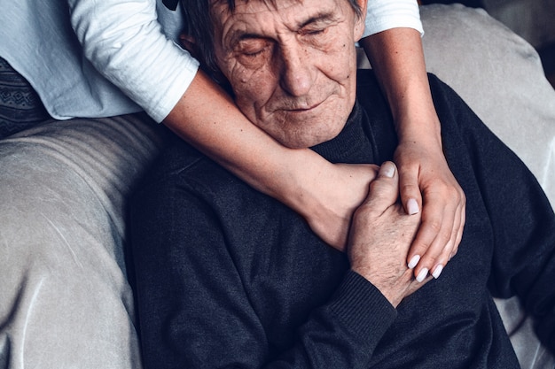 Daughter supports and takes care of her elderly father during the quarantine