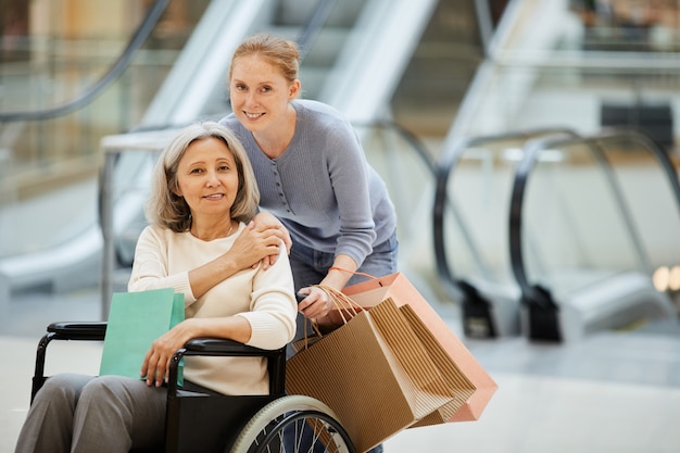 Daughter with disabled mother going for shopping
