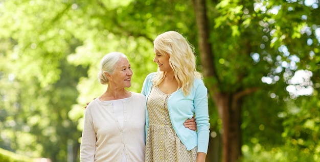 daughter with senior mother hugging at park