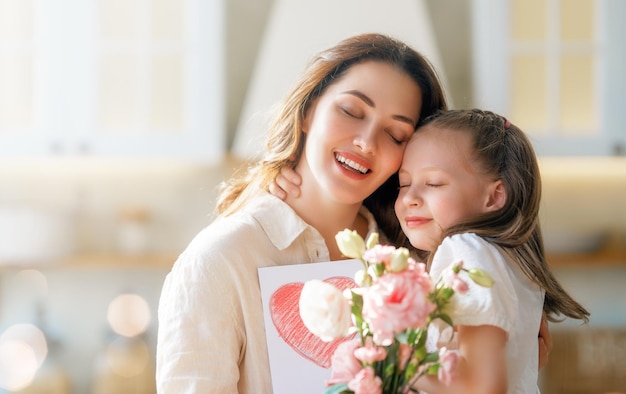 daughters giving mother bouquet of flowers