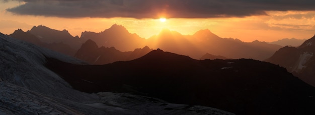 Dawn in the Caucasus Mountains, panorama landscape. Ridge, sharp peaks. Traveling in the mountains	