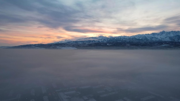 Dawn over the city in fog and smog mountain view