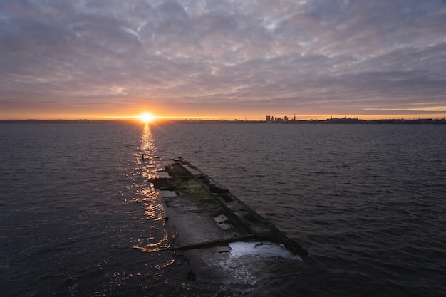 Dawn over the city of tallinn as seen from the sea from the shore of paljassaare