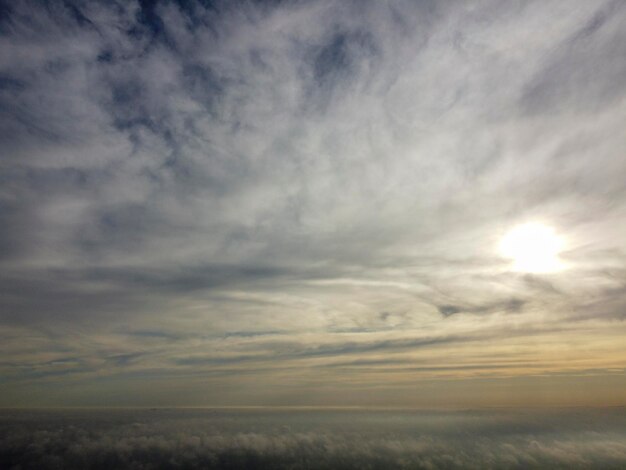 Dawn in the clouds over the morning mist sunrise behind the clouds and thick fog