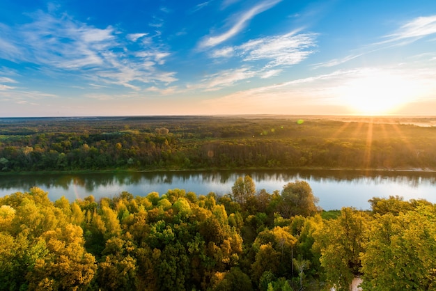 Dawn rays the sun over the river . rocky chalk coast. landscape panorama wallpaper.