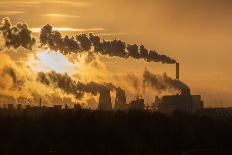 Photo dawn over the smoking chimneys heat power plant