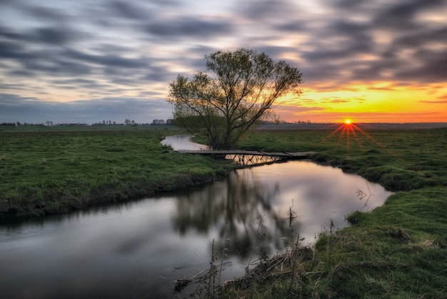 Dawn in the valley of a picturesque river