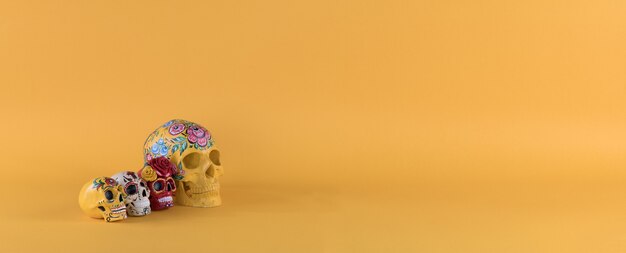 Day of the Dead colorful skulls on yellow background