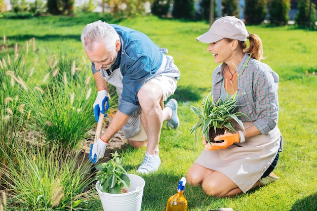 Day in garden. Happy beautiful couple feeling memorable and extremely happy while spending their day in garden