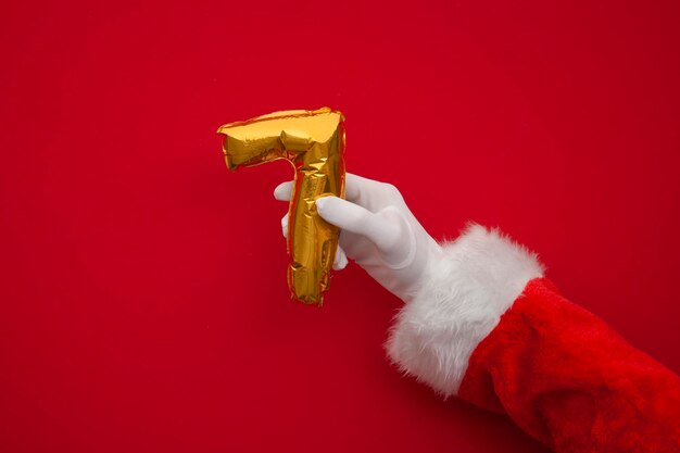 days of christmas santa hands holding th day balloon on red background