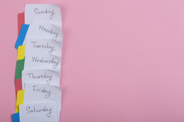 The days of the week the paper stickers attached to the pink background