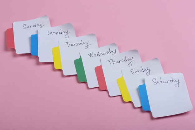 The days of the week the paper stickers attached to the pink background