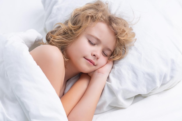 Daytime sleep cute child sleeping on bed at home bedtime kid sleeps kid asleep on soft pillow with b