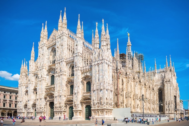 Daytime view of famous Milan Cathedral (Duomo di Milano) on piazza in Milan, Italy