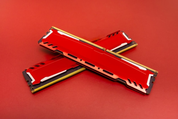 Ddr4 ram memory cards with red aluminum heat sinks on a matching color surface arranged