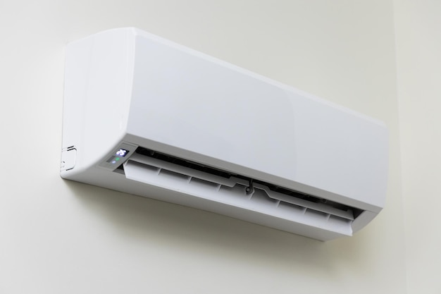 De airconditioner wordt aan de muur van het huis gehangen. Voor verkoeling in de woonkamer van het huis Maak de lucht koel