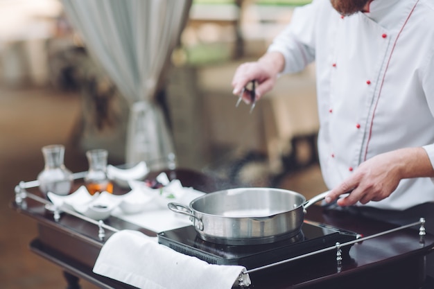 De chef-kok bereidt de Foie gras voor de gasten.