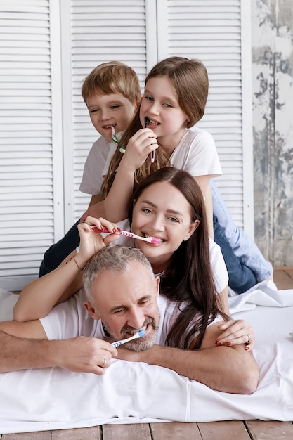 Foto de familie poetst hun tanden en lacht